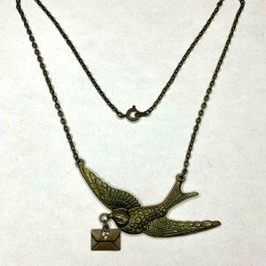 Brass toned bird with rhinestone envelope necklace